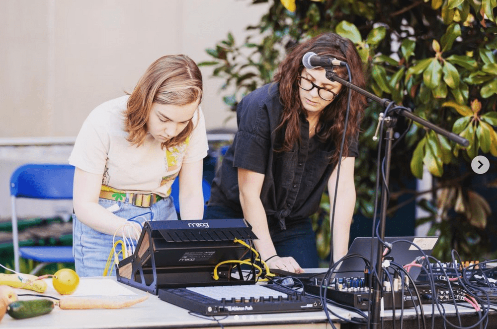 Heather Stebbins with a student and synth - Celebrate World Listening Day Celebration