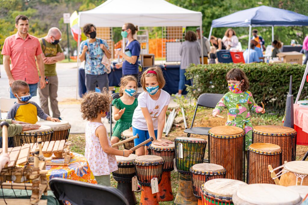 Kids playing hand drums at Down In The Reeds Festival