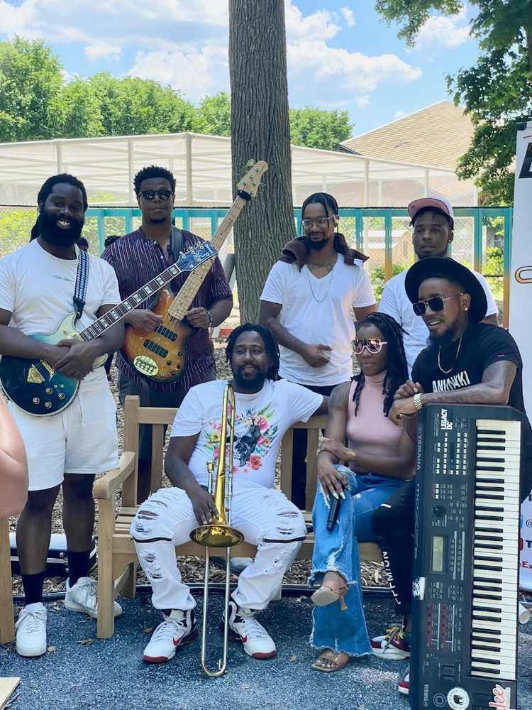 The Experience Band & Show poses together for a group photo.