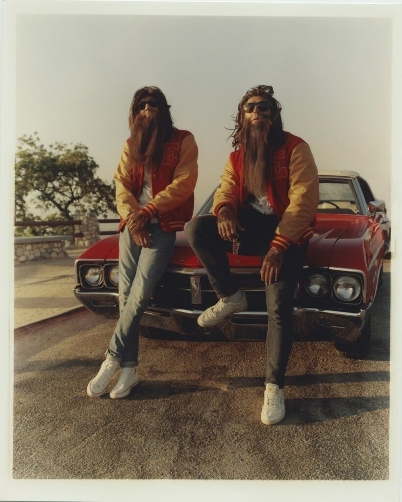 White and Scott in the "Stay" music video, dressed as werewolves in front of a red car