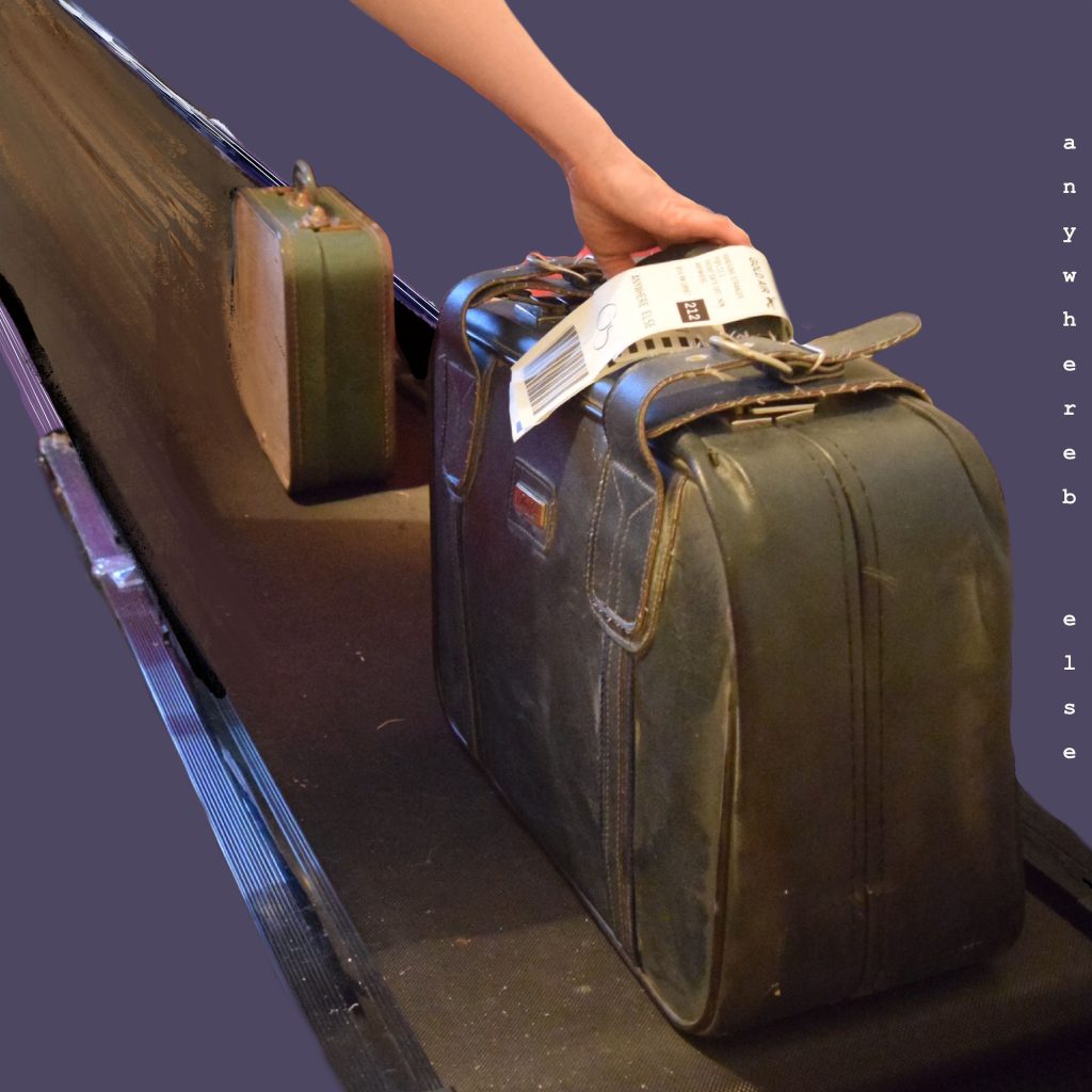 Gold Spectacles - Anywhere Else - album art shows a hand reaching for suitcases on a conveyor belt.