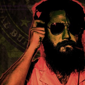 Tired All The Time "One Big File" album art with a bearded man wearing sunglasses and an orange hoodie listening to music on headphones.