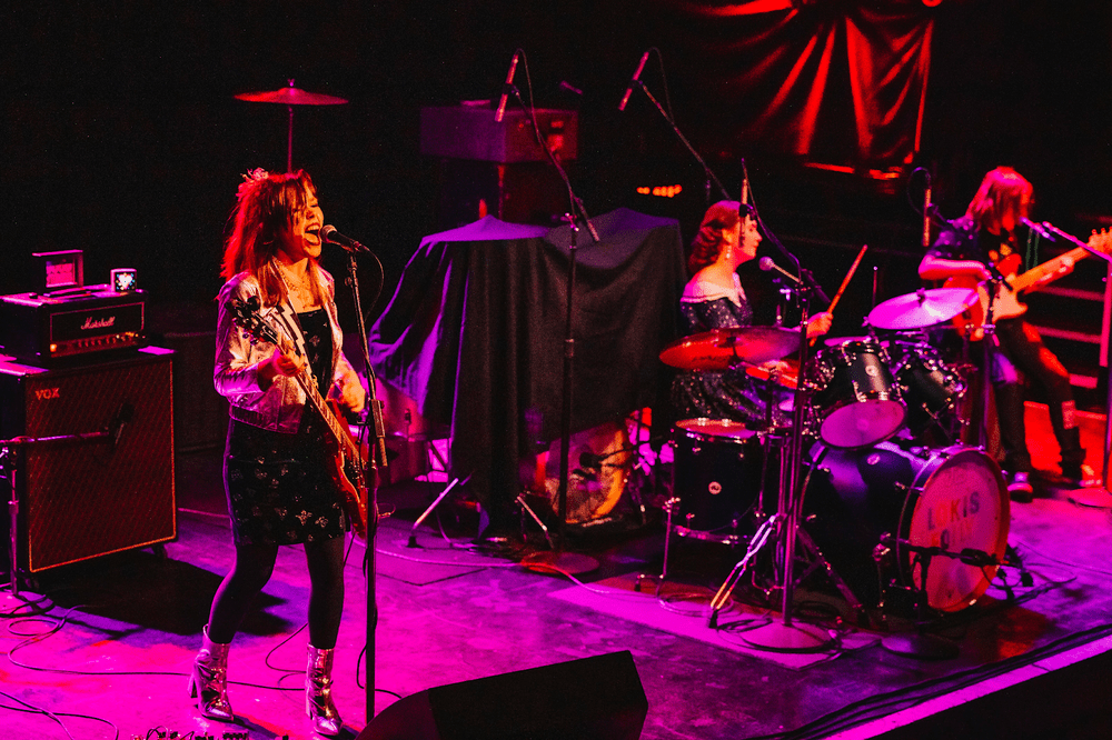 Annie performing onstage with Loki's Folly at First Avenue