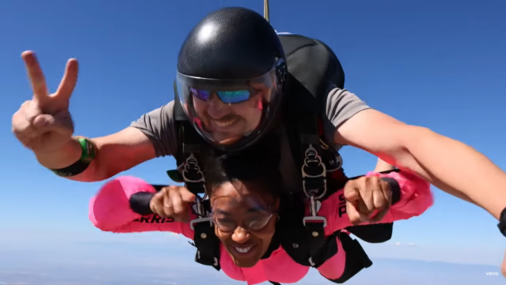 Amanda Brown and her skydiving instructor in mid flight. A screenshot from her music video for "Amazing"
