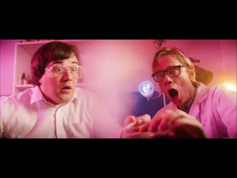 King Black Acid - Caterpillar Queen - music video thumbnail - depicting members of the band dressed like mad scientists awash in pink lighting
