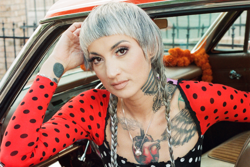 Luz Elena Mendoza of Y La Bamba poses in a car