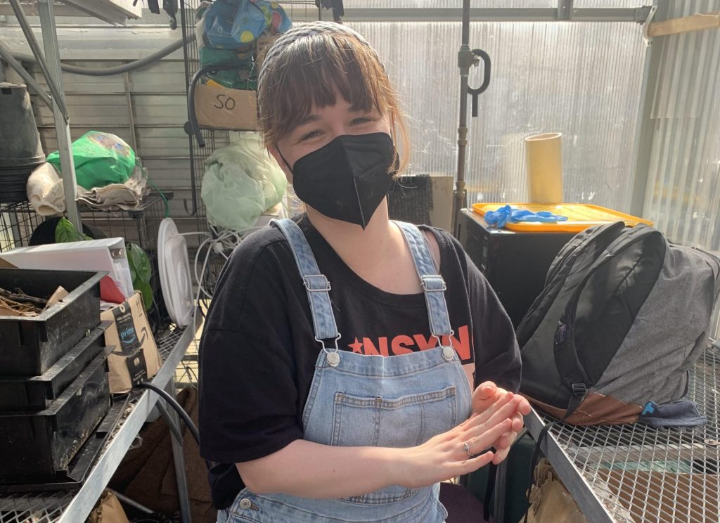 Author Maura Marcellino working in a greenhouse.