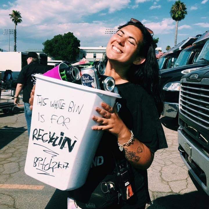 Lexis Yelissmiling while holding a recycling bin while working Van's Warped Tour 2017