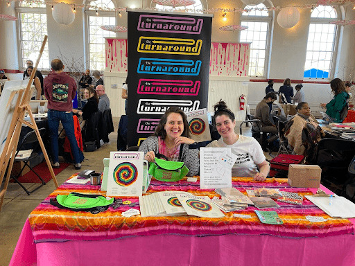 Amy and a colleague selling copies of WWJF's magazine at Eastern Market