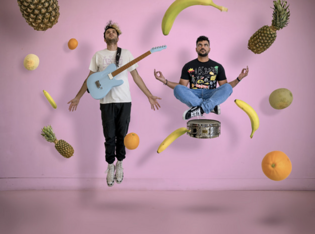 standards floating next to hovering fruit in midair in front of a pink background