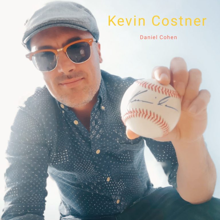 Daniel Cohen hold a baseball signed by "Kevin Costner"