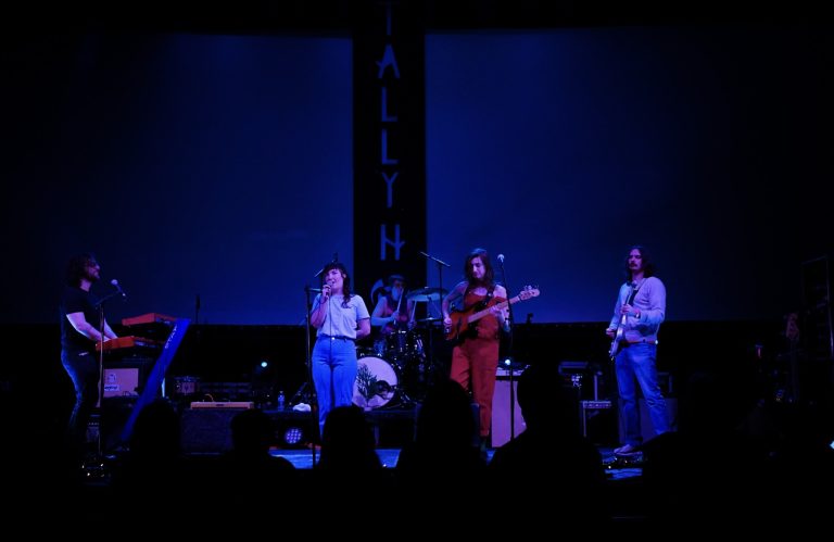 Pretty Bitter performing onstage with blue lighting