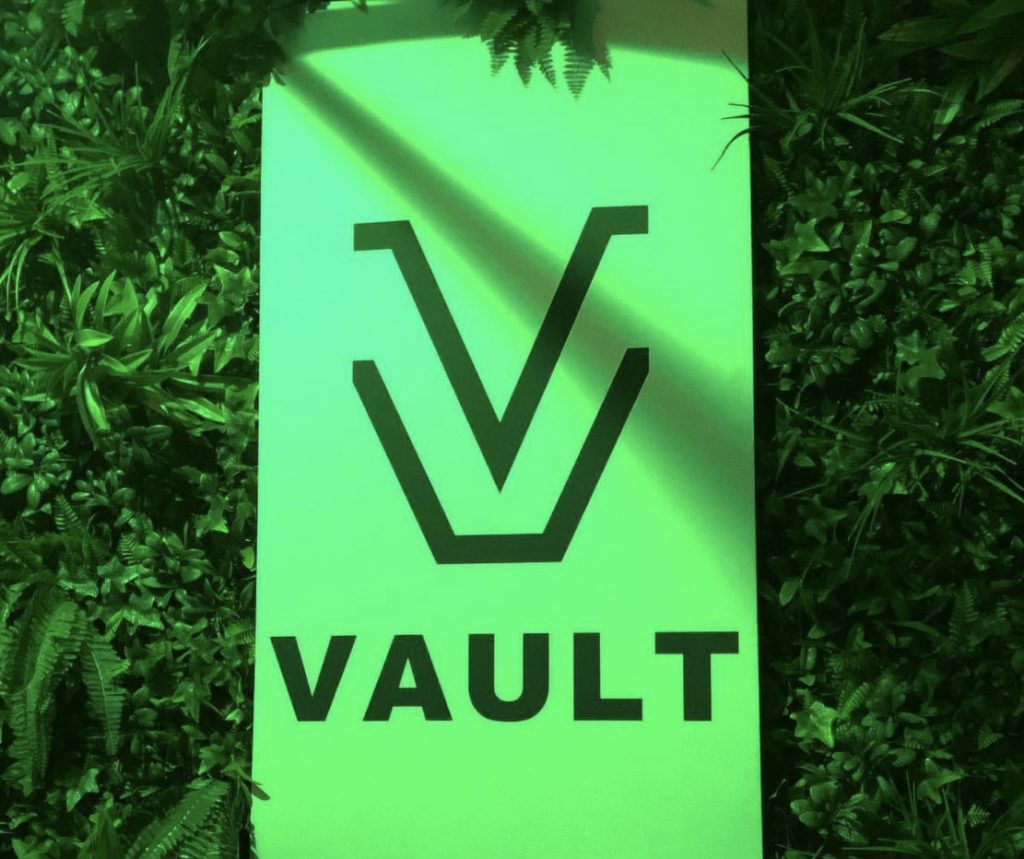 Vault Studio logo, green light and plants around caption: Photo by Lean’s Vision
