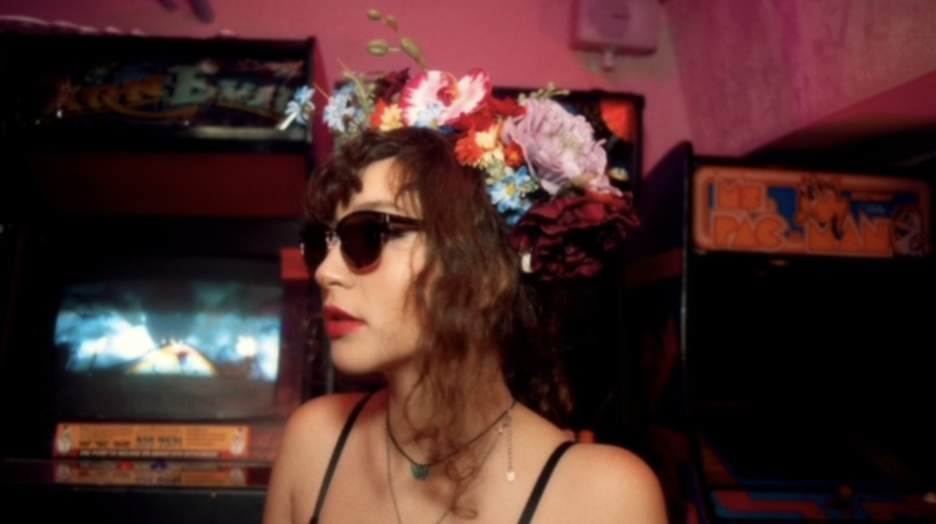 Calista Garcia wearing sunglasses and a flowery headdress.