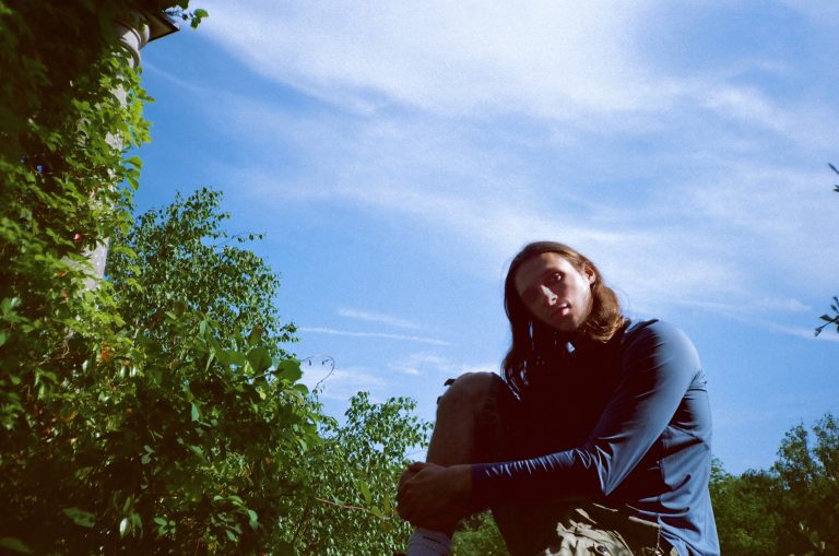ION sitting in a green field against a blue sky