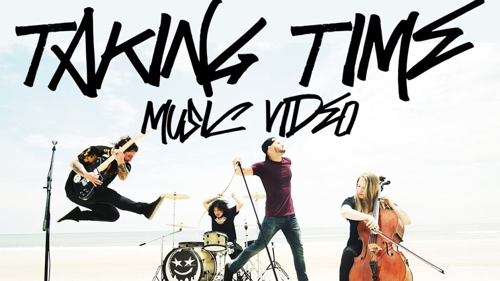 Free Friends "Take Time" music video thumbnail featuring the band members rocking out on a beach.