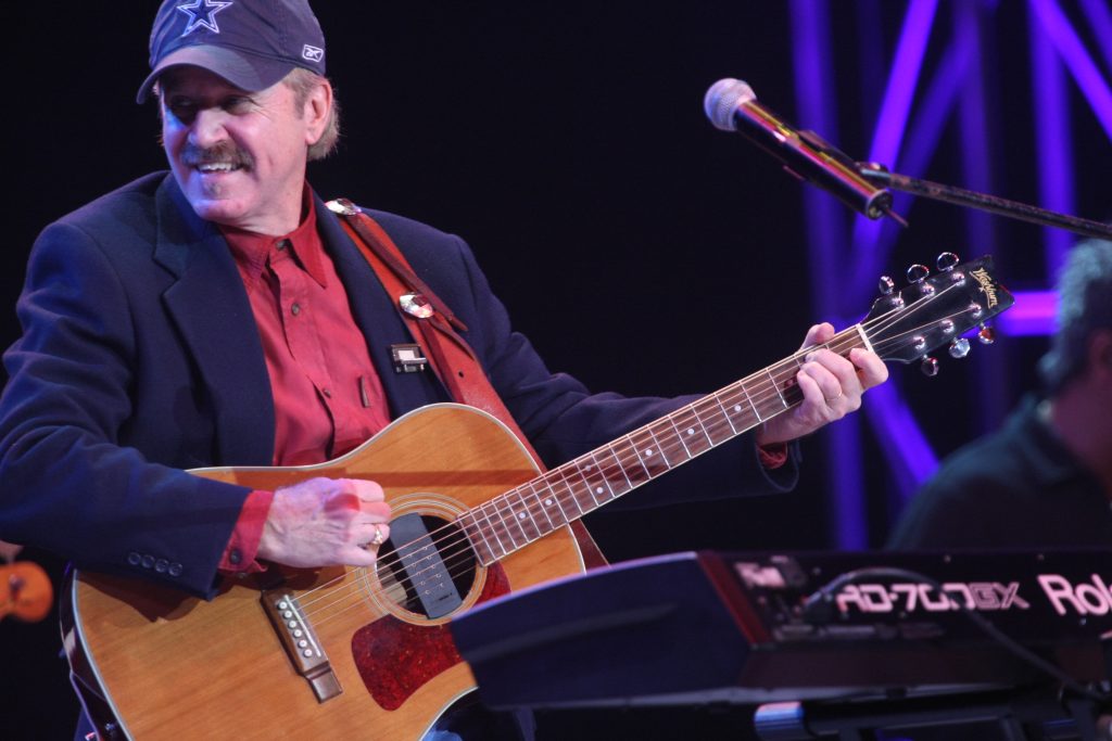 John Ford Coley plays live on stage with band