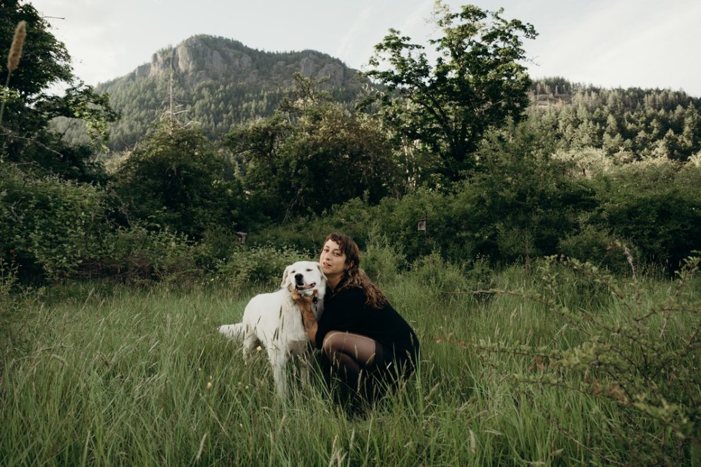 An image of Ora Cogan outside with her dog