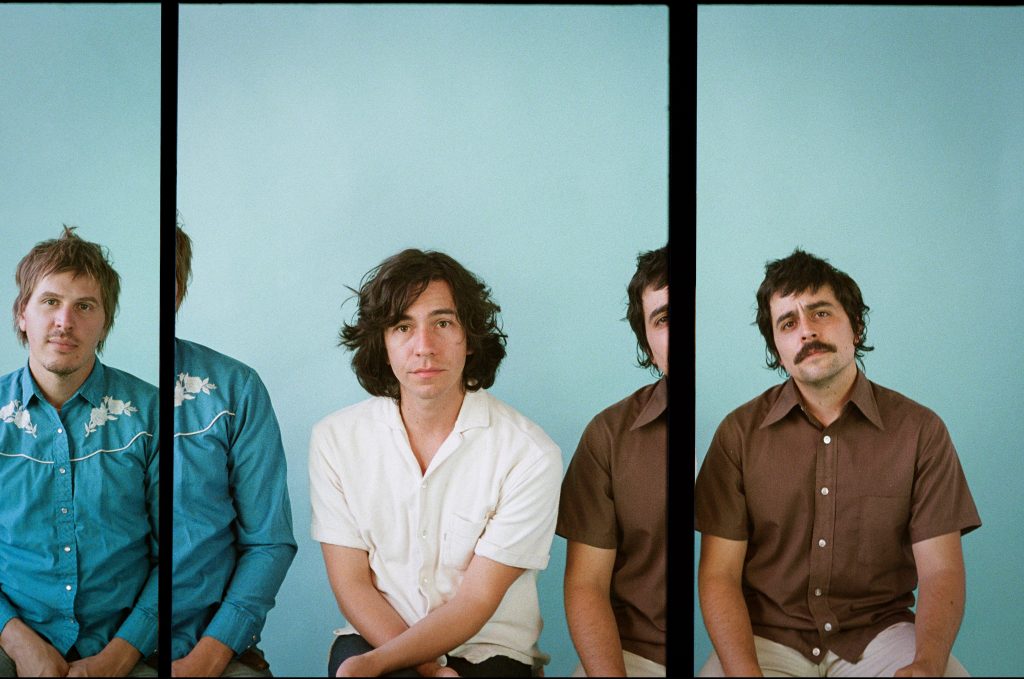 French Cassettes in a seated pose for the photo, bringing to mind a classic film reel.