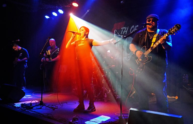 A shot of DC-based rock band 5th of Four performing live on stage.