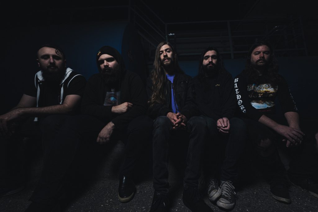 Hardcore band Detachment poses for a seated promo photo.