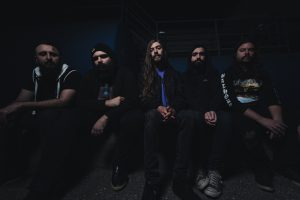 Hardcore band Detachment poses for a seated promo photo.