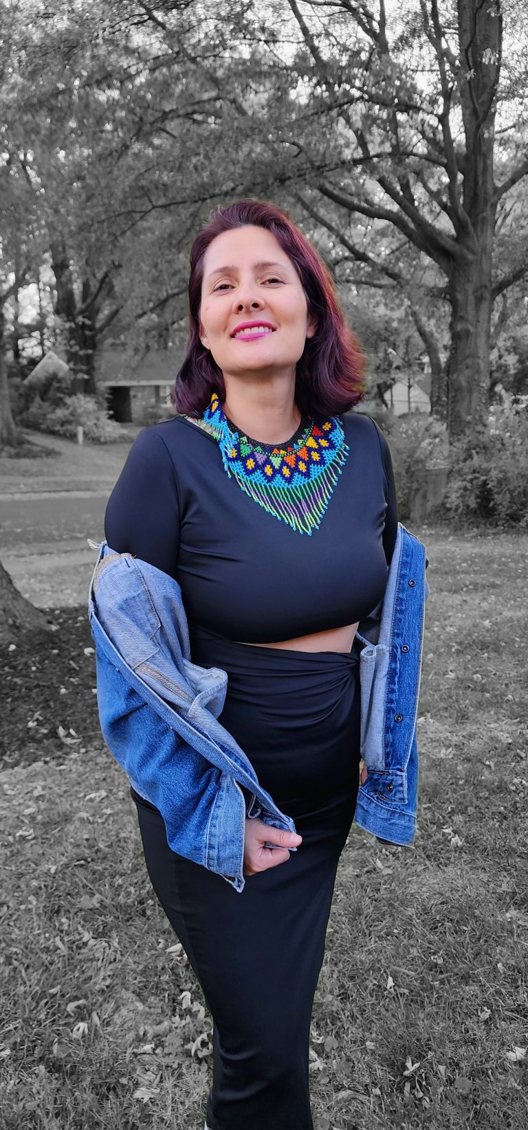 elu O poses in festive clothing in outdoor photo with black and white background.