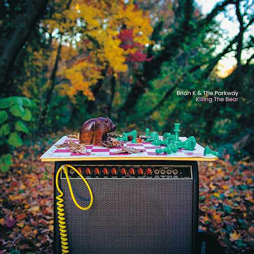 Brian K. & The Parkway "Wind The Clock" album art depicting a guitar amplifier in the middle of the forest surrounded by Fall foilage.