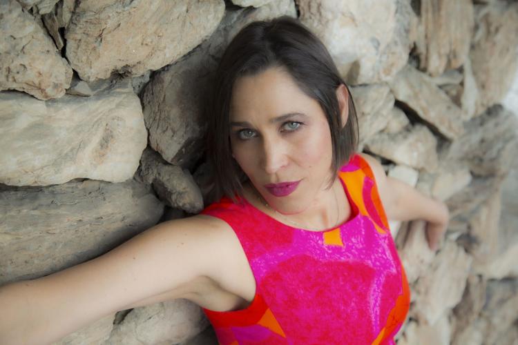 China Forbes standing in front of stone wall