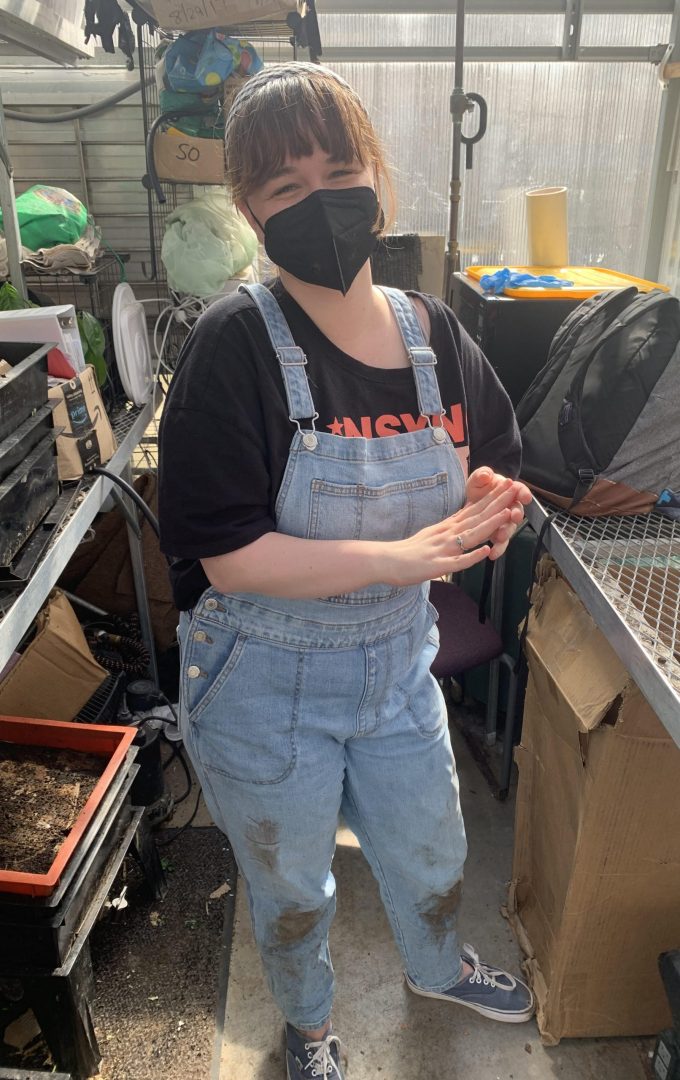 Author Maura Marcellino working in a greenhouse.