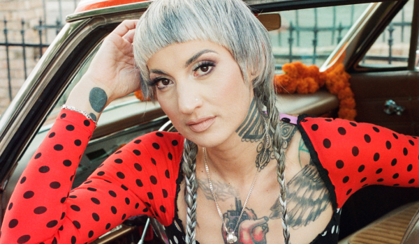 Luz Elena Mendoza of Y La Bamba poses in a car